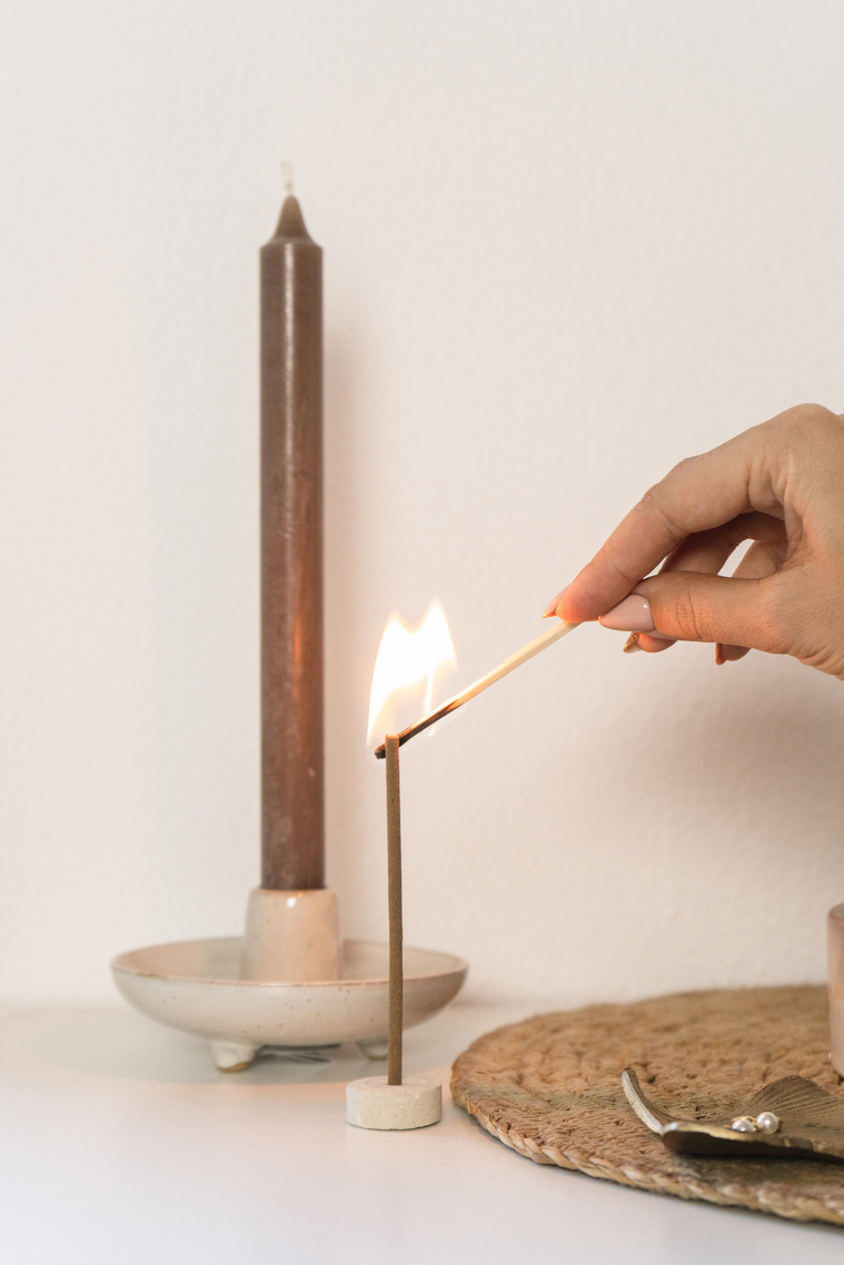 Woman Lighting a Candle